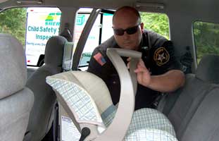 Officer installing a car seat